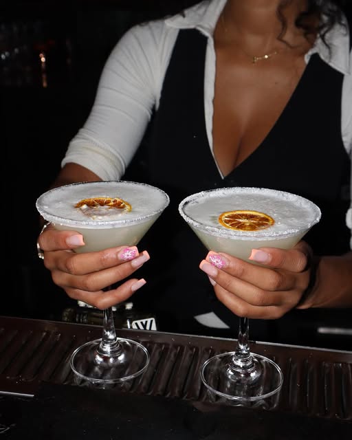Two salt-rimmed margaritas served at the bar