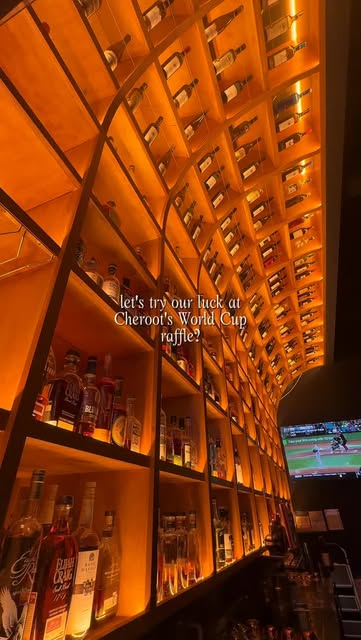 The illuminated bottle wall rising over the bar